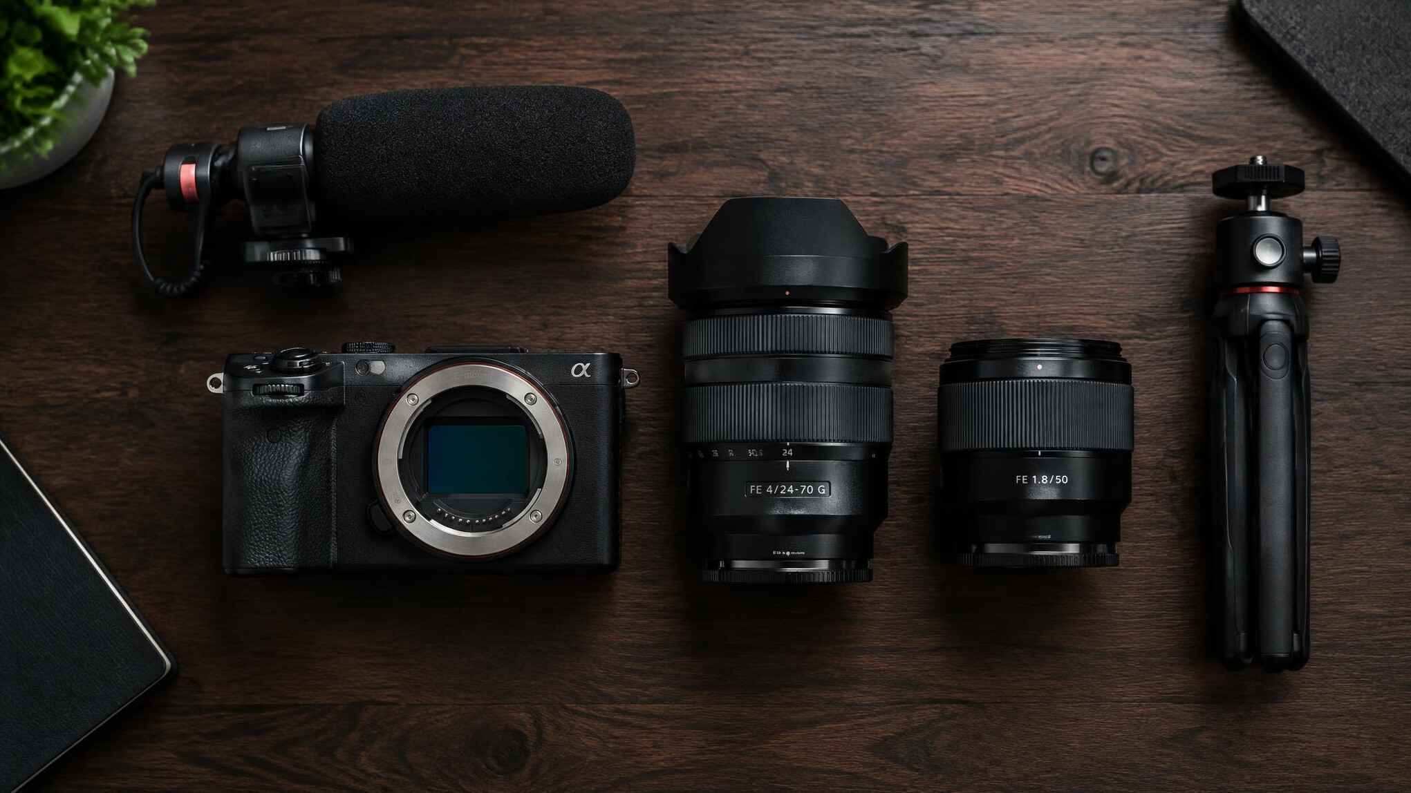 Professional video camera and lenses laid out on a studio desk